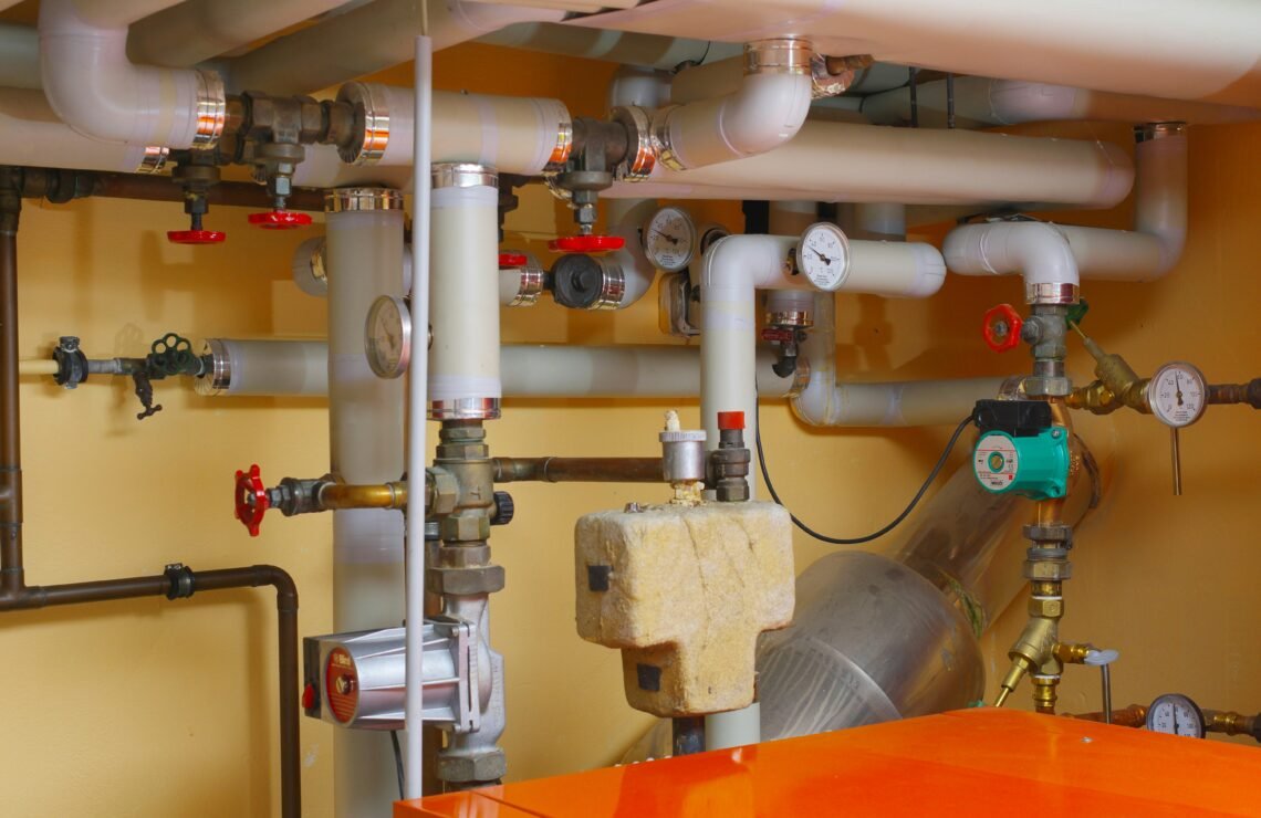 pipes and valves in a room with orange table